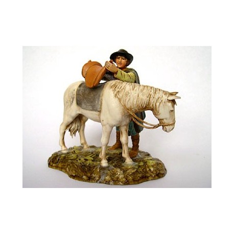 Pastore che sella cavallo